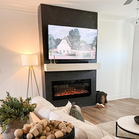 Touchstone Sideline Electric Fireplace with dark gray fireplace wall and light mantel by @oliveandoakhome
