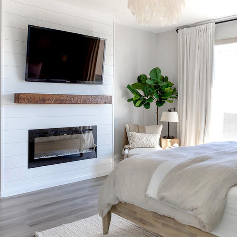 Touchstone Sideline Electric Fireplace with white shiplap accent wall in bedroom by @solxrosehome