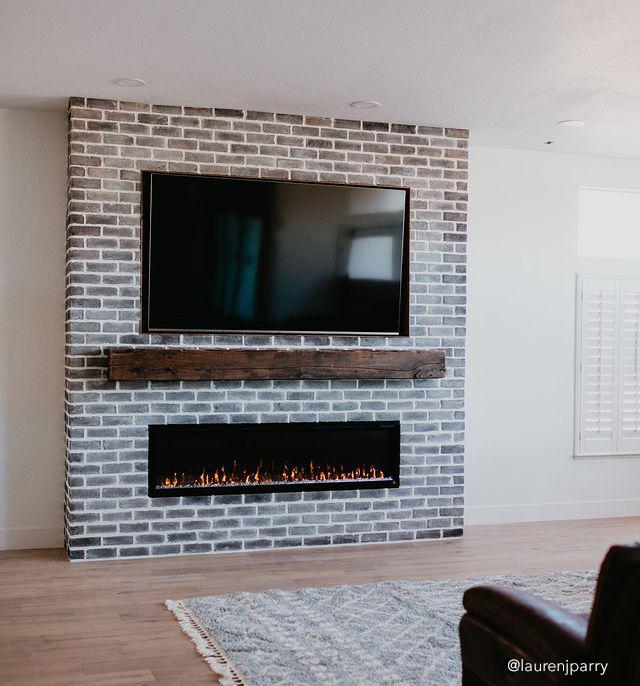 Sideline Elite Smart 80050 84 WiFi-Enabled Recessed Electric Fireplace in a brick wall.