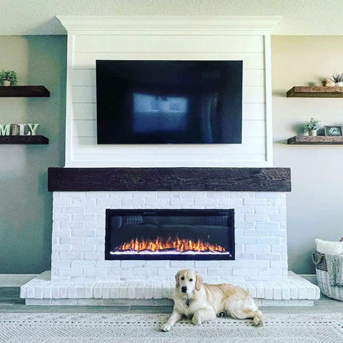 Touchstone Sideline Elite Electric Fireplace with white brick and dark wood mantel by McKinnon Building Services