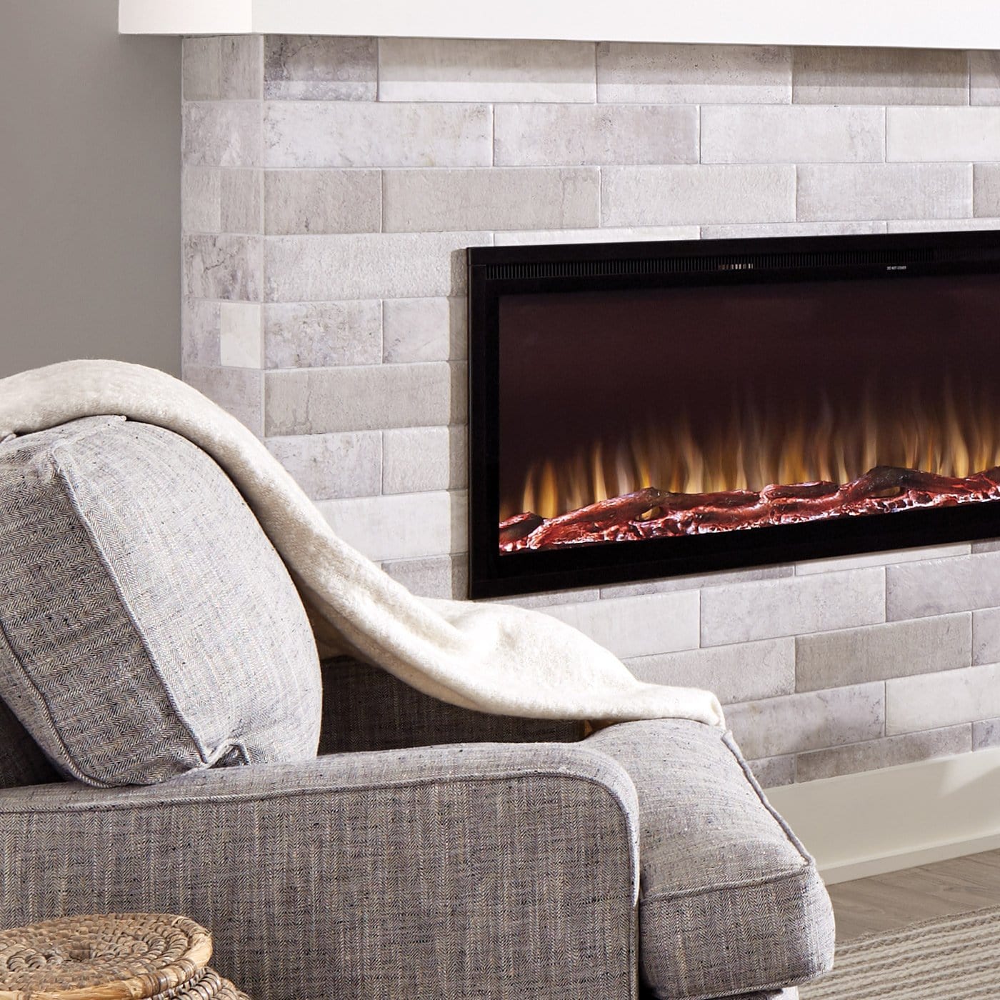 Touchstone Sideline Elite Electric Fireplace with logs in white brick mantel