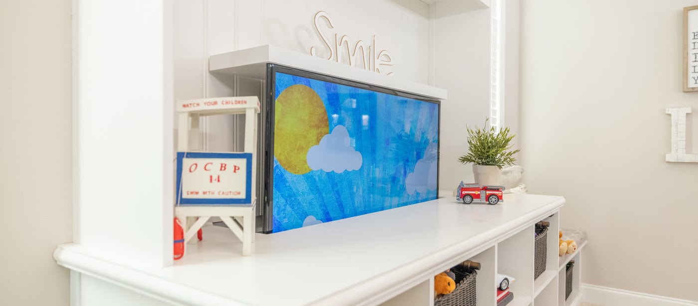 Touchstone motorized TV lift is installed in playroom accent wall