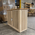 Touchstone Elevate Mission Smart TV Lift Cabinet in unfinished photographed in the warehouse - showroom unit.