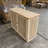 Touchstone Elevate Mission Smart TV Lift Cabinet in unfinished photographed in the warehouse - showroom unit.