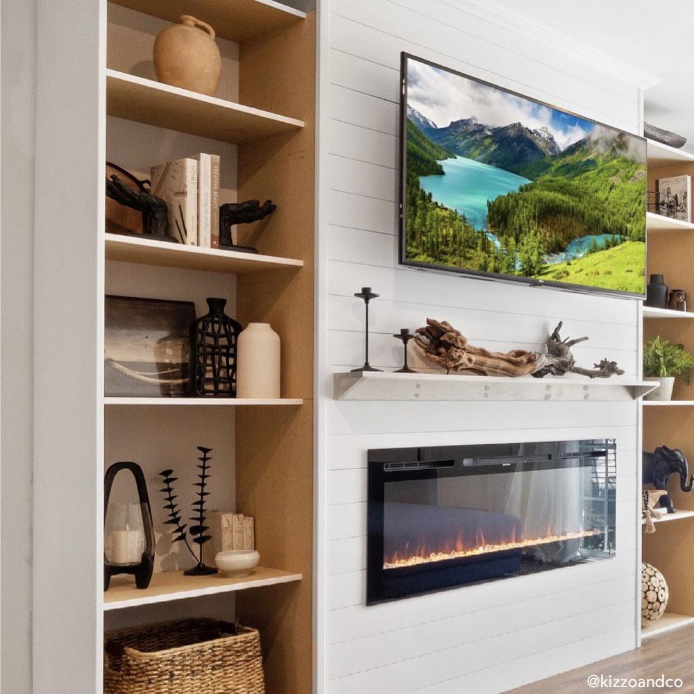 Touchstone Sideline 50 Electric Fireplace in white shiplap wall surrounded by bookcases by @kizzoandco